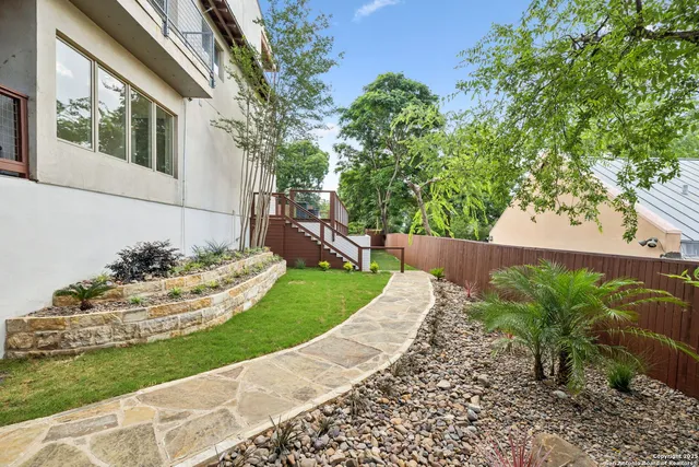 a front view of a house with a garden and yard