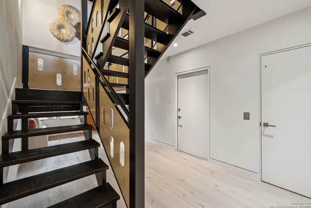 a view of an entryway with wooden floor