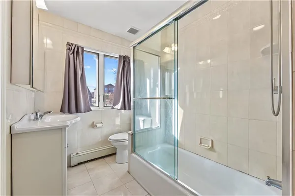 a bathroom with a granite countertop sink mirror bathtub and shower