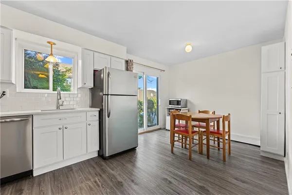 a kitchen with wooden floors and white appliances