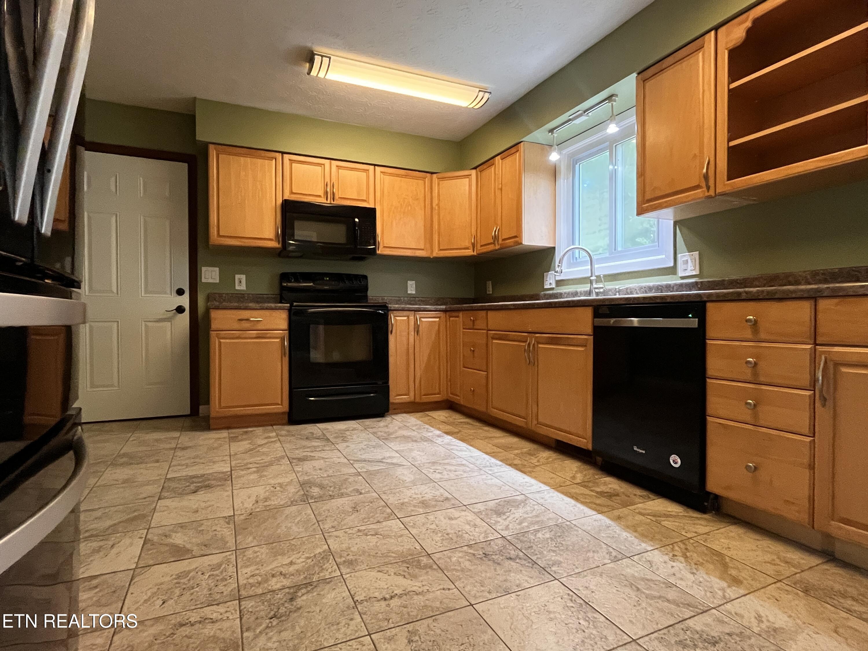 104 Clark Lane Oak Ridge, TN 37830 - Photo 14 of 23 Kitchen Overlooks Fenced Yard, Woods
