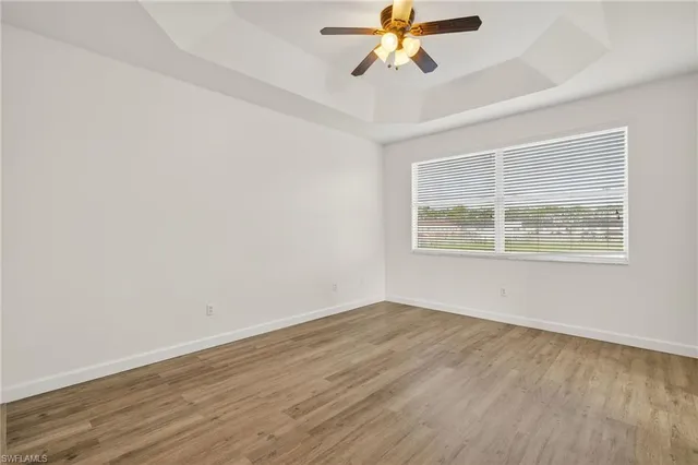 a view of a room with wooden floor and windows
