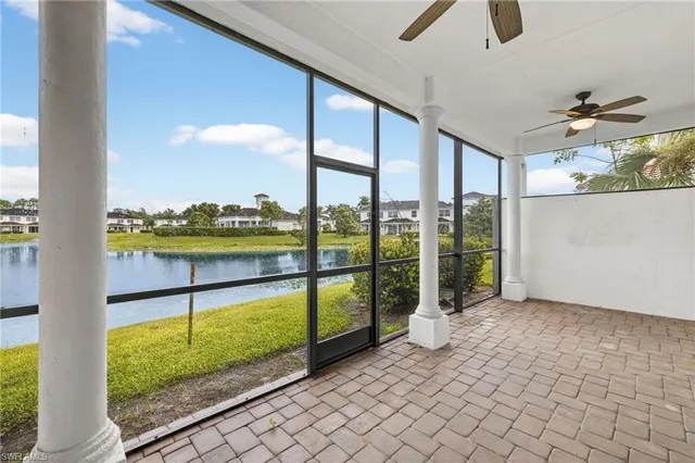 a view of a porch with a floor to ceiling window and a table