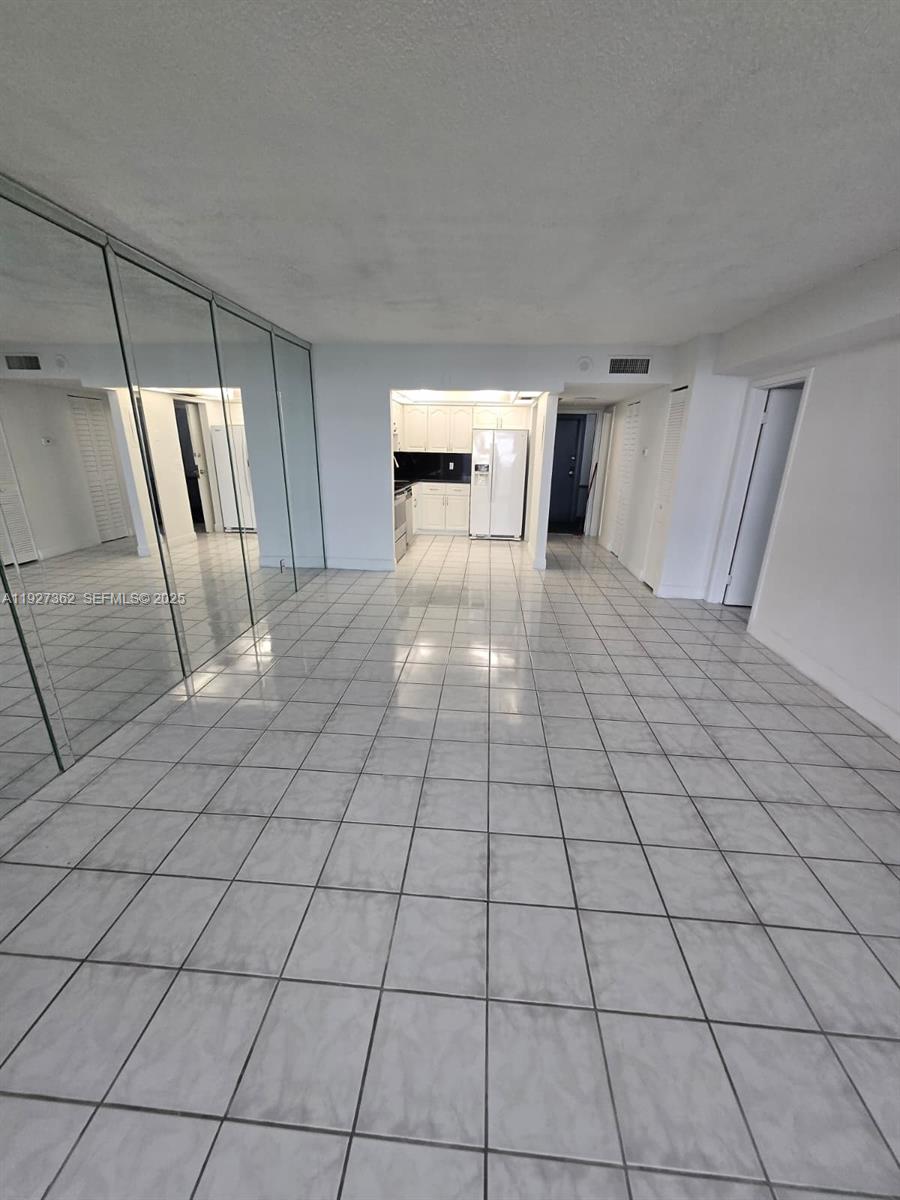 13499 Biscayne Boulevard, Unit 1204 North Miami, FL 33181 - Photo 1 of 13 a view of empty room with wooden floor