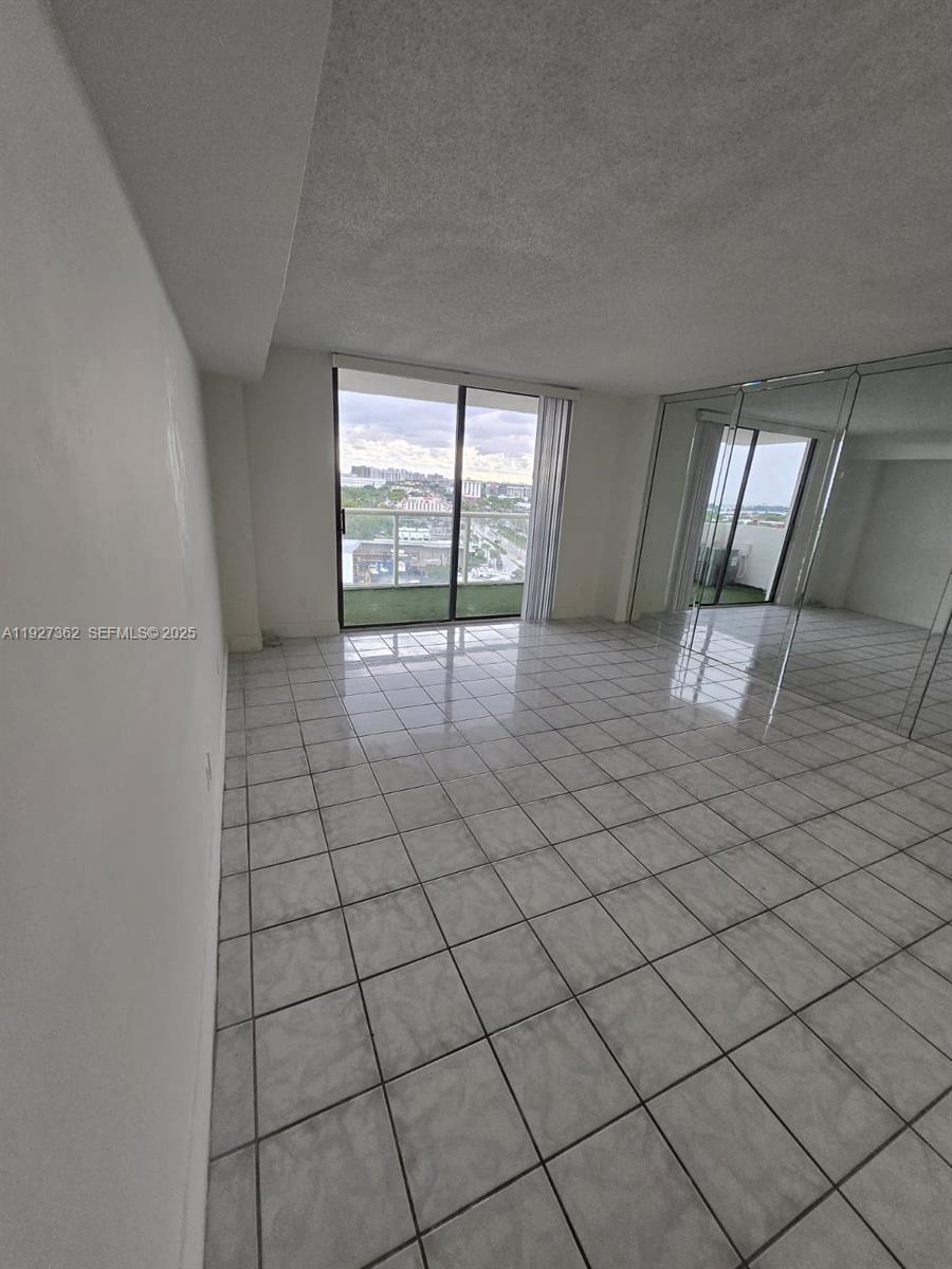 13499 Biscayne Boulevard, Unit 1204 North Miami, FL 33181 - Photo 2 of 13 an empty room with windows
