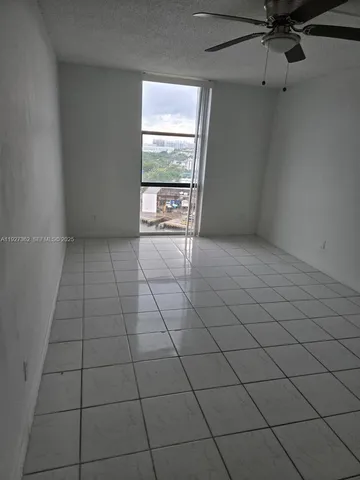 a view of an empty room and a window