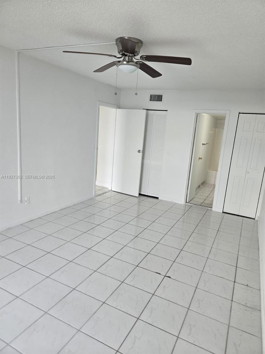 13499 Biscayne Boulevard, Unit 1204 North Miami, FL 33181 - Photo 9 of 13 a view of an empty room and wooden floor