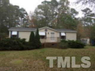 216 New Creech Road Selma, NC 27576 - Photo 1 of 14 a front view of a house with a yard