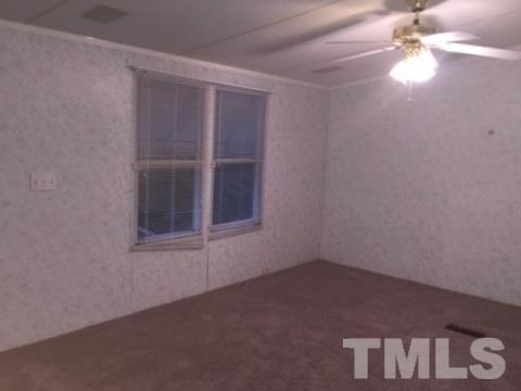 216 New Creech Road Selma, NC 27576 - Photo 2 of 14 an empty room with a window