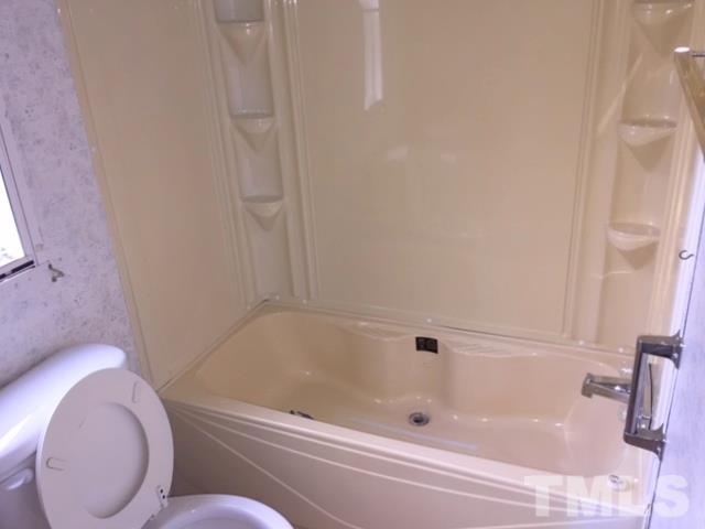216 New Creech Road Selma, NC 27576 - Photo 11 of 14 a bathroom with a bathtub and toilet