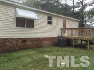 216 New Creech Road Selma, NC 27576 - Photo 12 of 14 a backyard of a house with table and chairs