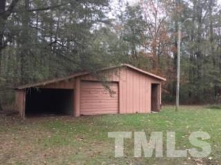 216 New Creech Road Selma, NC 27576 - Photo 13 of 14 a backyard of a house with lots of green space