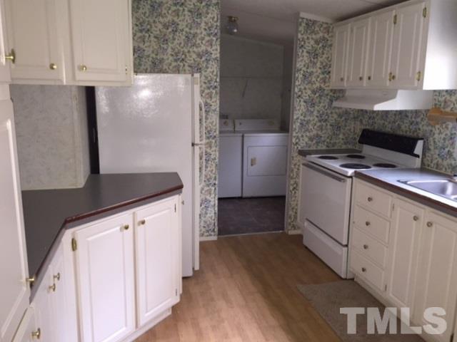 216 New Creech Road Selma, NC 27576 - Photo 4 of 14 a kitchen with stainless steel appliances a sink and a refrigerator