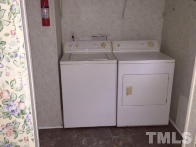 216 New Creech Road Selma, NC 27576 - Photo 6 of 14 a utility room with dryer and washer