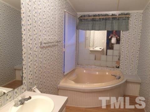 216 New Creech Road Selma, NC 27576 - Photo 8 of 14 a bathroom with a sink and a tub