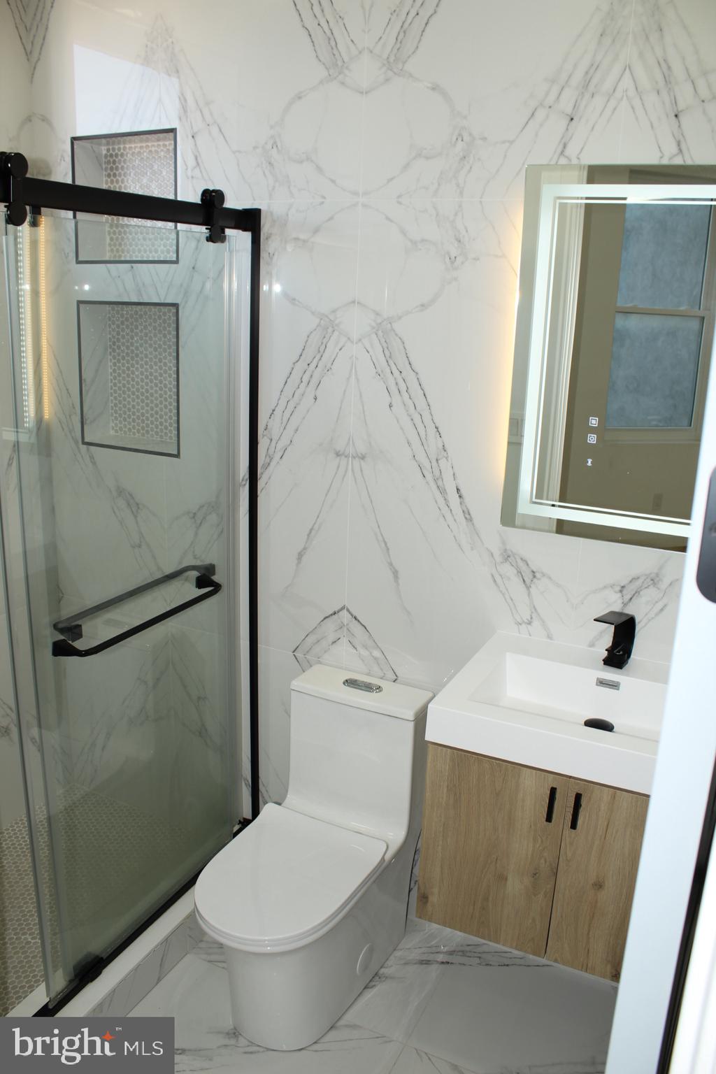 3017 Ridge Avenue, Unit C Philadelphia, PA 19121 - Photo 20 of 27 Sleek modern bathroom with elegant tiles.