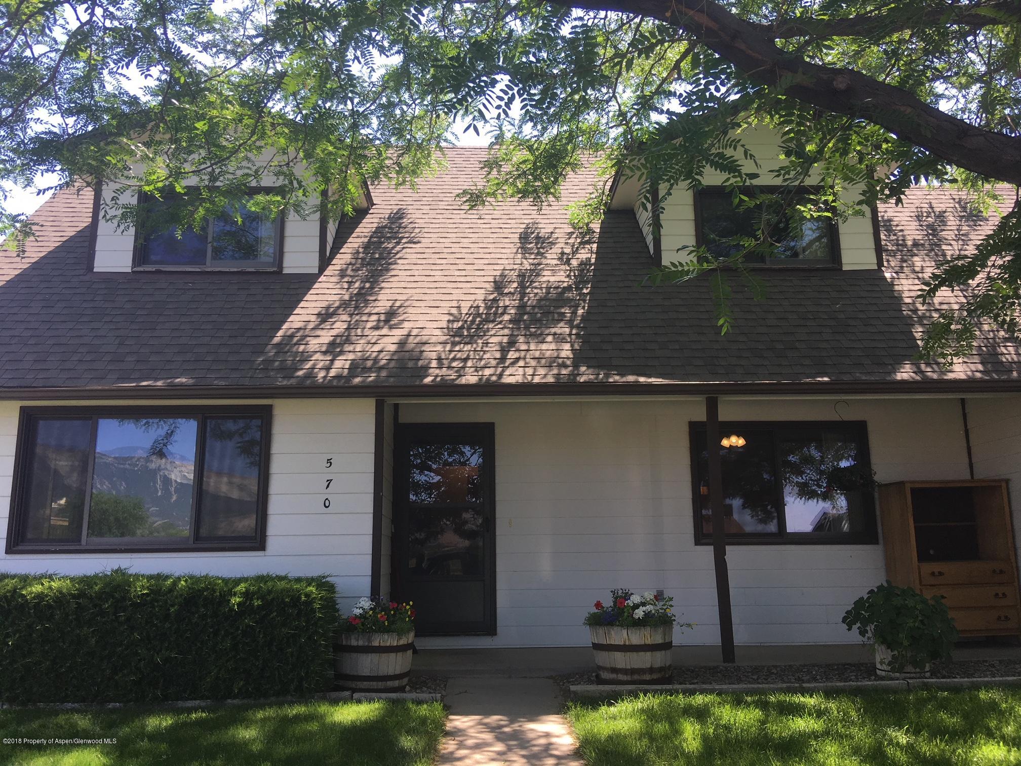 570 Will Avenue Rifle, CO 81650 - Photo 1 of 13 a front view of a house with garden