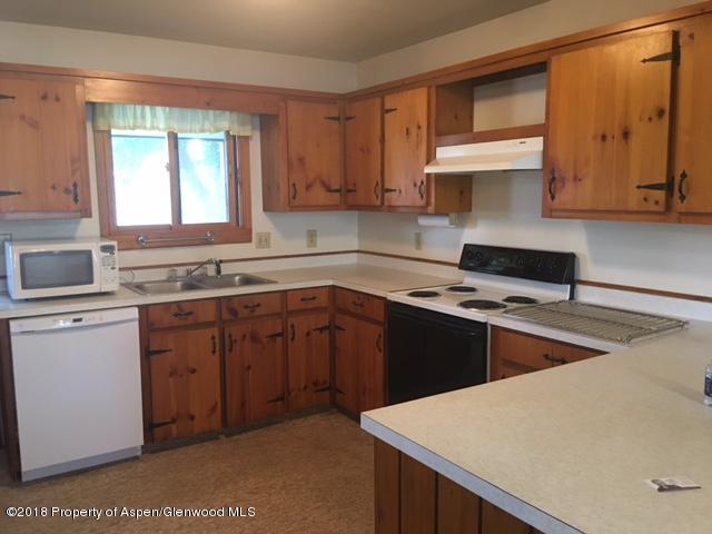570 Will Avenue Rifle, CO 81650 - Photo 3 of 13 a kitchen with a stove a sink and a microwave