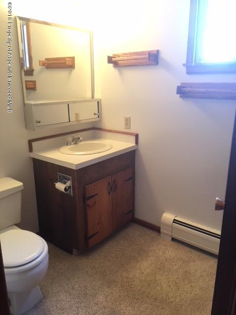 570 Will Avenue Rifle, CO 81650 - Photo 6 of 13 a bathroom with a sink a toilet and a mirror