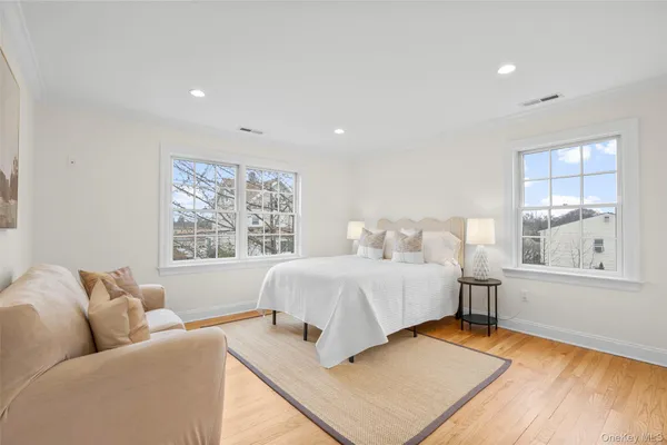 a large bedroom with a bed and a large window