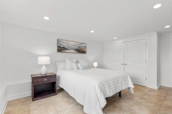 a bedroom with a bed and wall painting