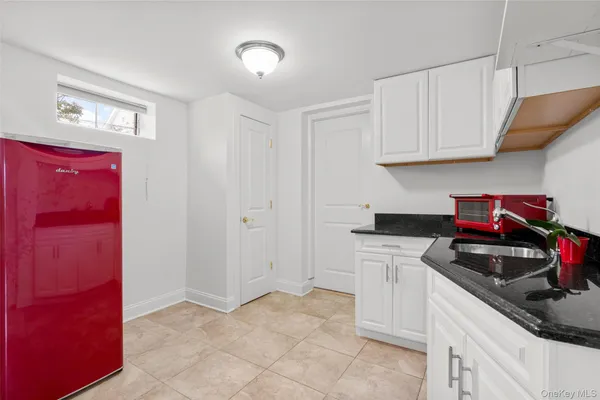 a kitchen with granite countertop a sink and cabinets