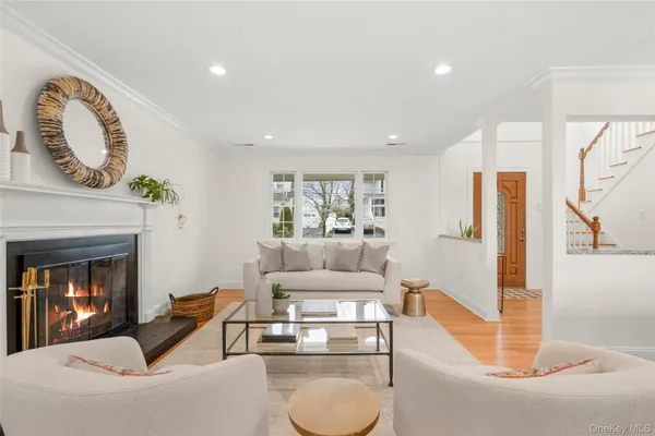 a living room with furniture a fireplace and a chandelier