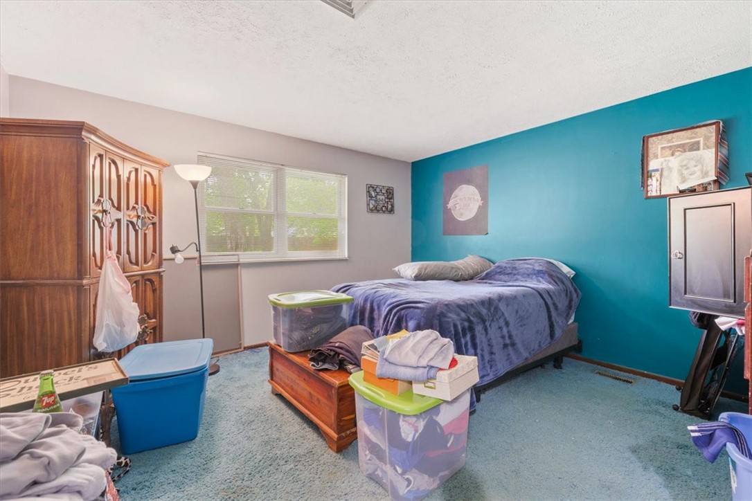 7225 Garber Road Clayton, OH 45415 - Photo 17 of 33 This cozy bedroom features ample natural light and plush carpeting, creating a serene personal retreat.