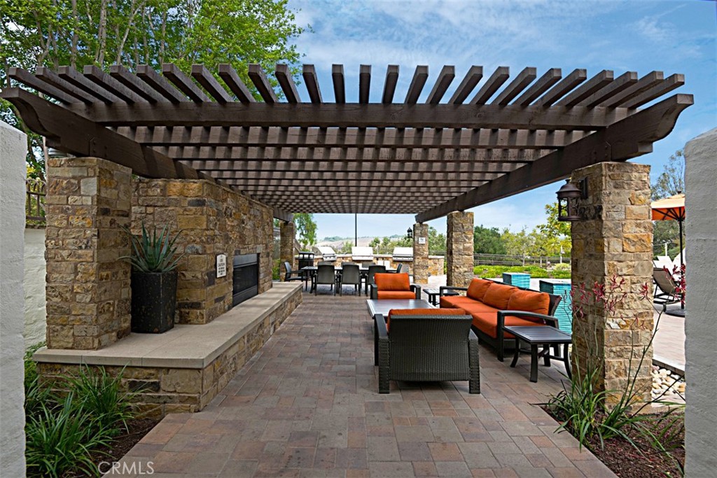 56 Acorn Ridge Rancho Santa Margarita, CA 92688 - Photo 56 of 57 Community Lounge / Barbecue Area: Open-air gathering space combines shaded seating, stone fireplace features, and convenient access to the barbecue area.