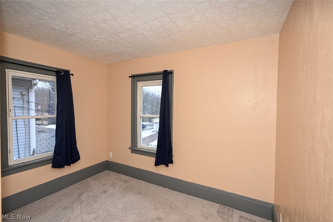 77 West Mildred Avenue Akron, OH 44310 - Photo 18 of 40 Empty room with carpet floors and a textured ceiling