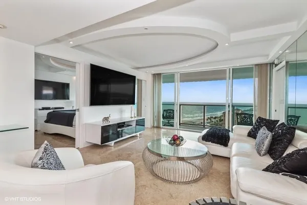 a living room with furniture and a flat screen tv