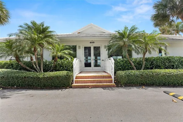 a kitchen with stainless steel appliances kitchen island granite countertop a table chairs microwave and sink