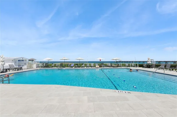a view of a patio with a table and chairs under an umbrella
