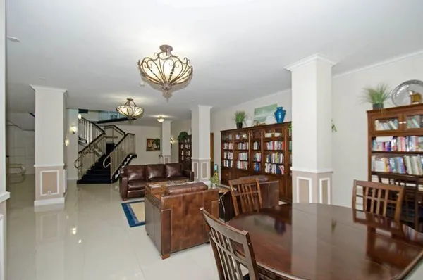 an aerial view of a house with a garden and lake view