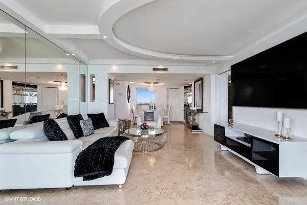 a very nice looking dining room with a large dining table and a chandelier