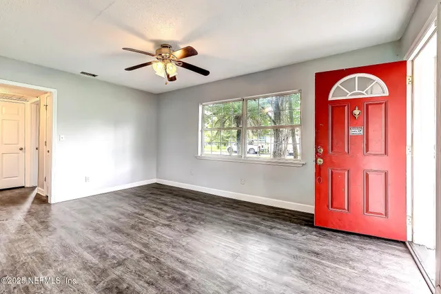 an empty room with closet and windows