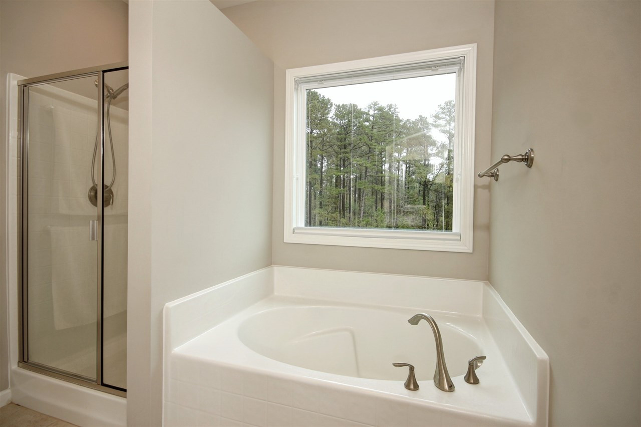 620 Edgewater Ridge Court Apex, NC 27523 - Photo 18 of 30 Owner's Bathroom includes separate shower and bathrub
