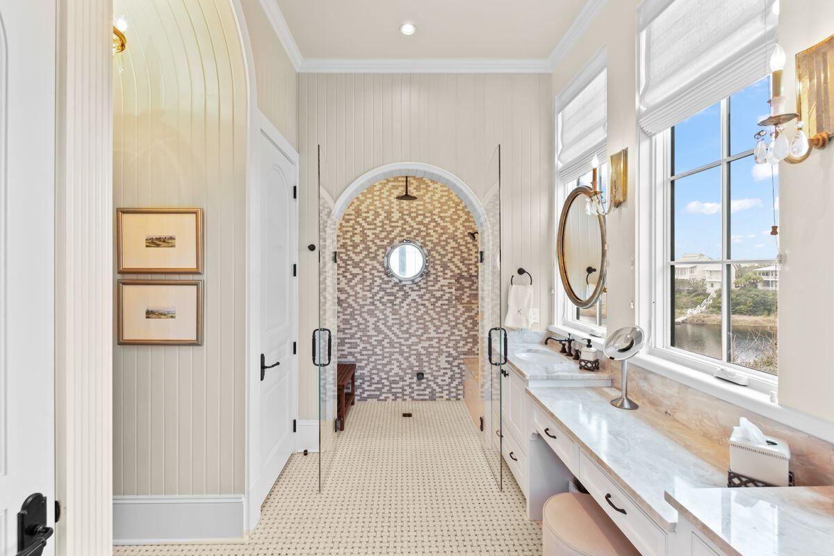 243 West Bermuda Drive Santa Rosa Beach, FL 32459 - Photo 17 of 37 a spacious bathroom with a double vanity sink a mirror and a shower