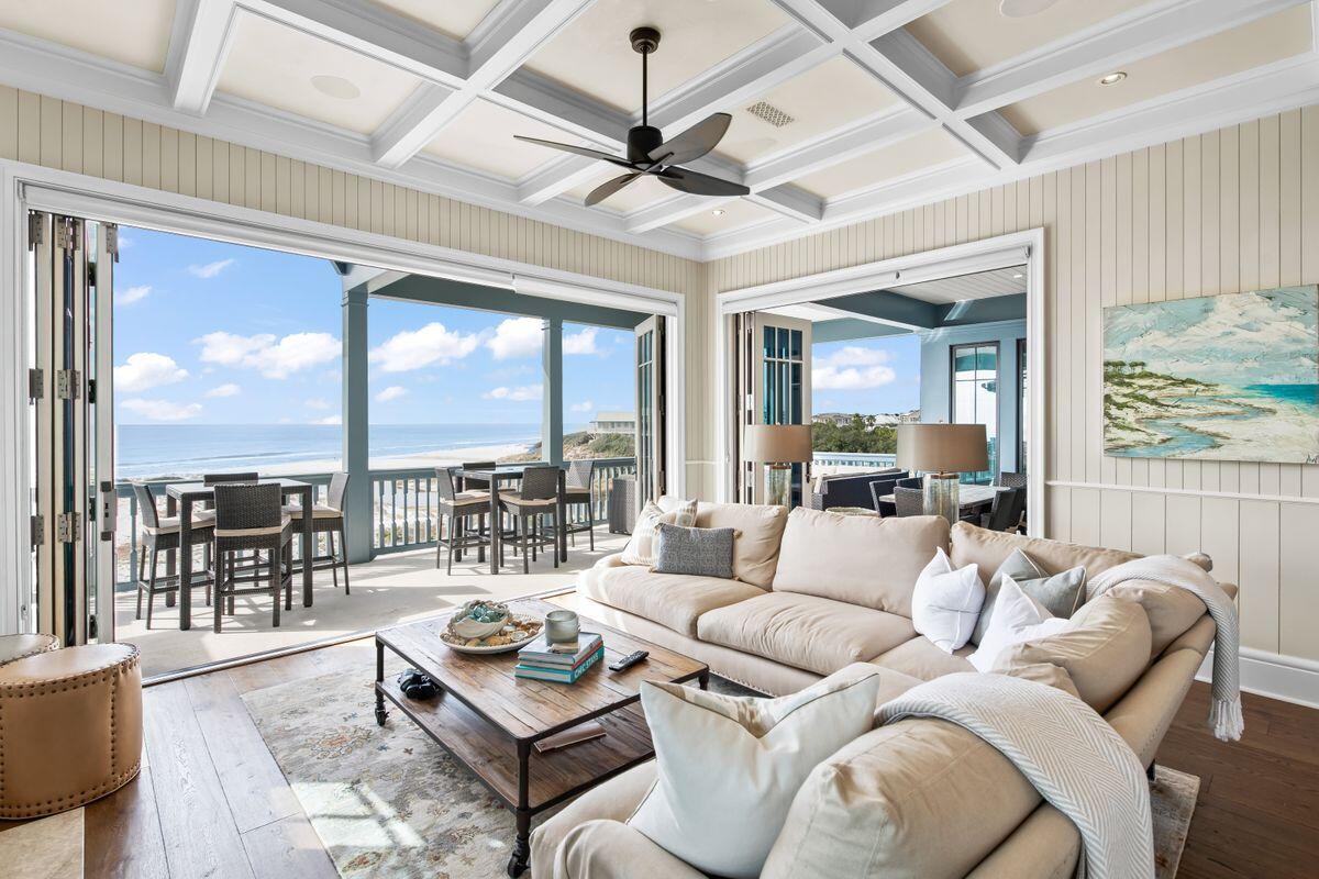 243 West Bermuda Drive Santa Rosa Beach, FL 32459 - Photo 7 of 37 a living room with furniture floor to ceiling windows and a ceiling fan