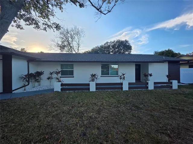 a view of a porch with furniture and a yard