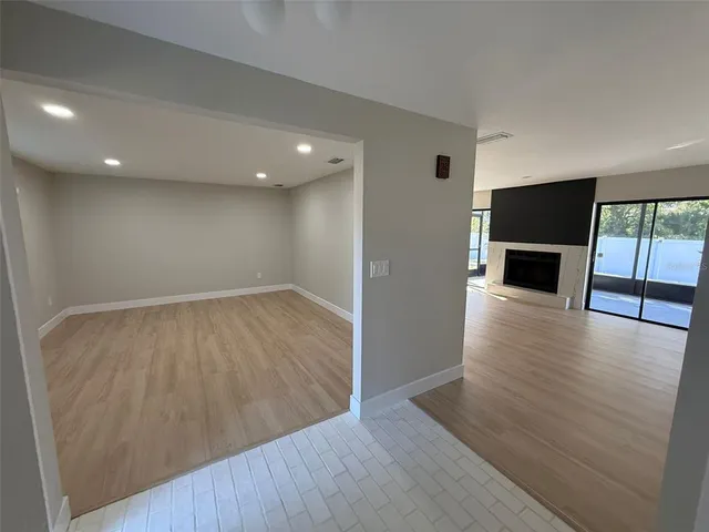 a kitchen with wooden floors and stainless steel appliances