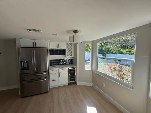 a bathroom with a granite countertop sink a toilet a mirror and shower