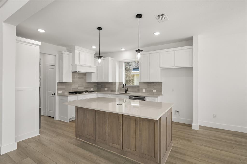 3714 Milwaukee Avenue Midlothian, TX 76065 - Photo 23 of 40 a kitchen with kitchen island a sink stainless steel appliances and cabinets