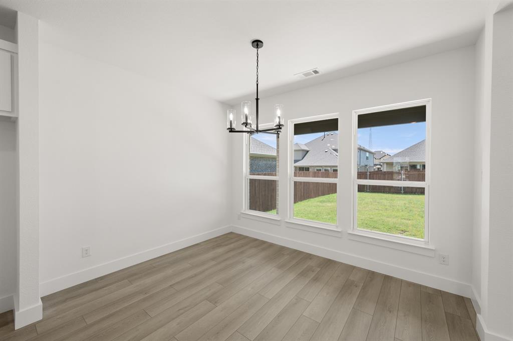 3714 Milwaukee Avenue Midlothian, TX 76065 - Photo 28 of 40 a view of an empty room with wooden floor and a window