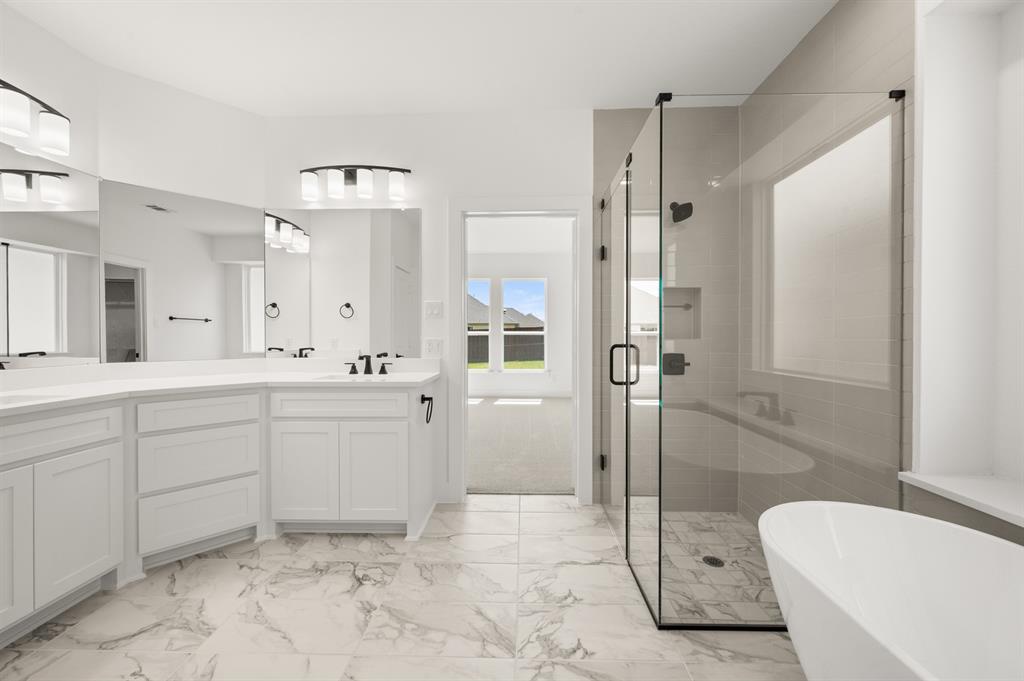 3714 Milwaukee Avenue Midlothian, TX 76065 - Photo 33 of 40 a spacious bathroom with a shower sink and mirror