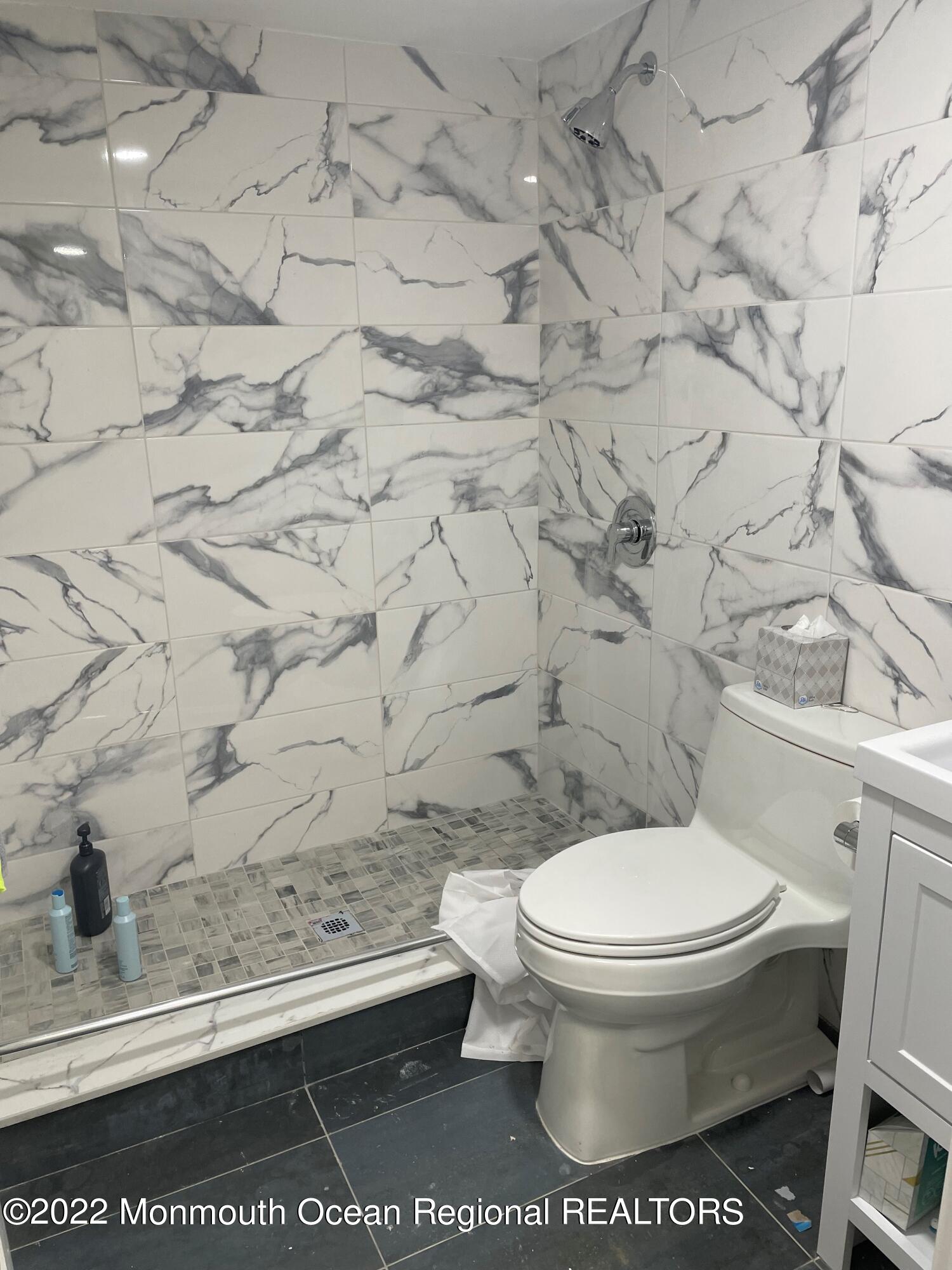 104 Pear Street, Unit WINTER Oakhurst, NJ 07755 - Photo 11 of 17 a white toilet sitting next to a shower