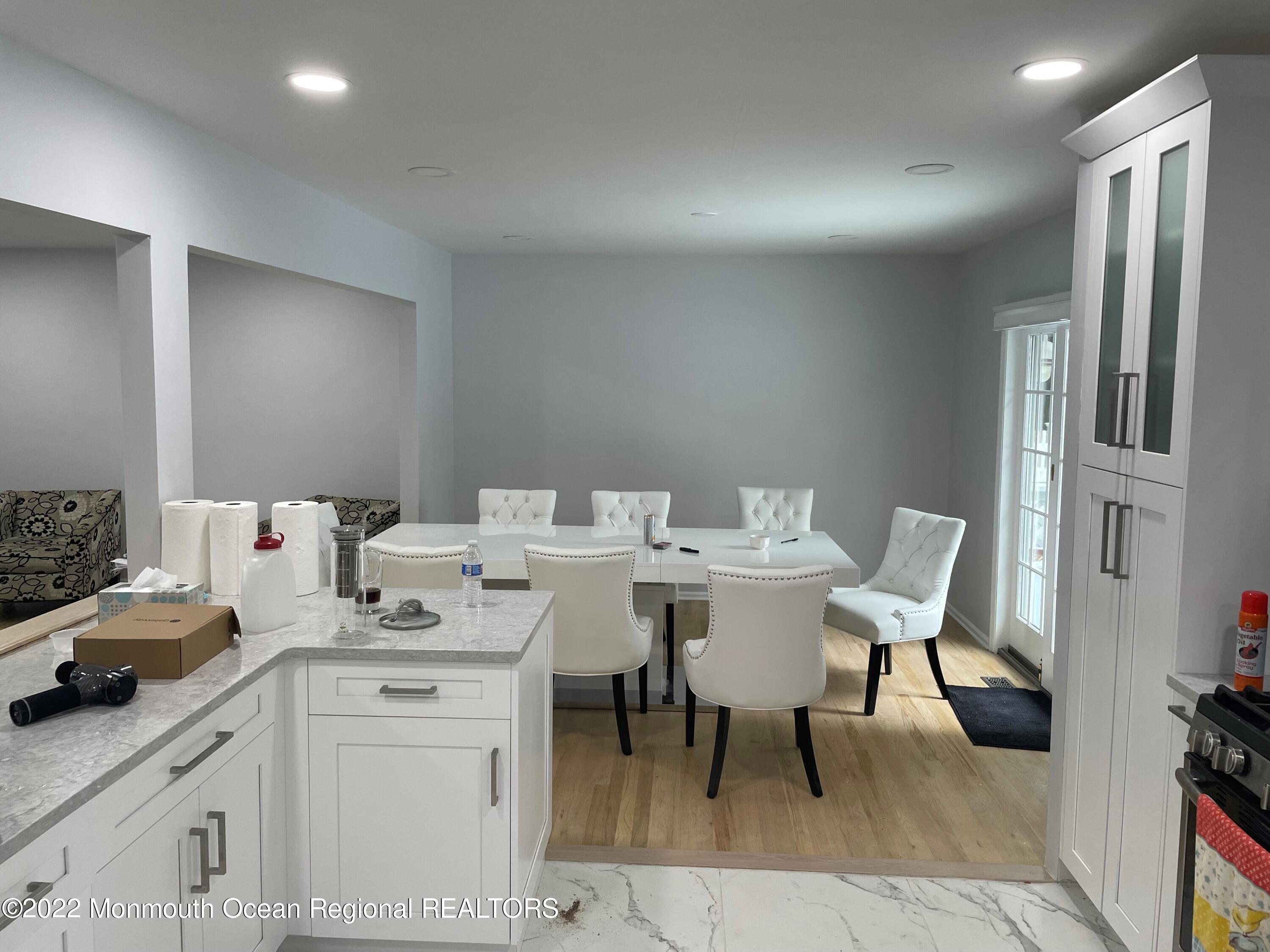 104 Pear Street, Unit WINTER Oakhurst, NJ 07755 - Photo 7 of 17 a kitchen with a table chairs and entryway