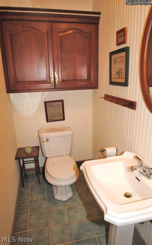 478 Koontz Road Wadsworth, OH 44281 - Photo 8 of 19 Cherry accents and ceramic tile floor are features of the 1st floor half bath.