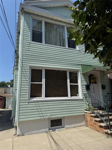 a view of a house with a door and a tree