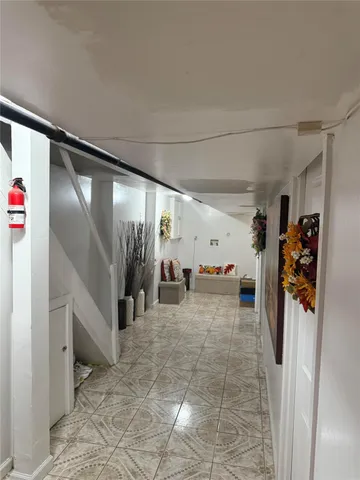 a view of a hallway with a couch and a stove